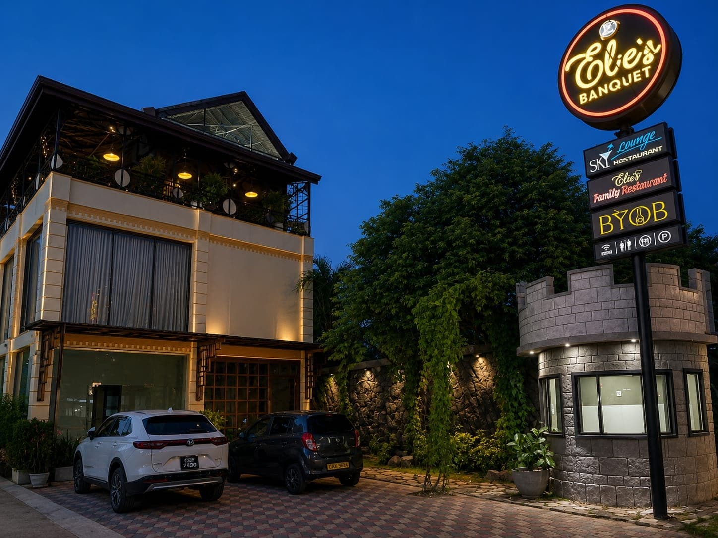 Elie's Banquet building and lit sign at dusk