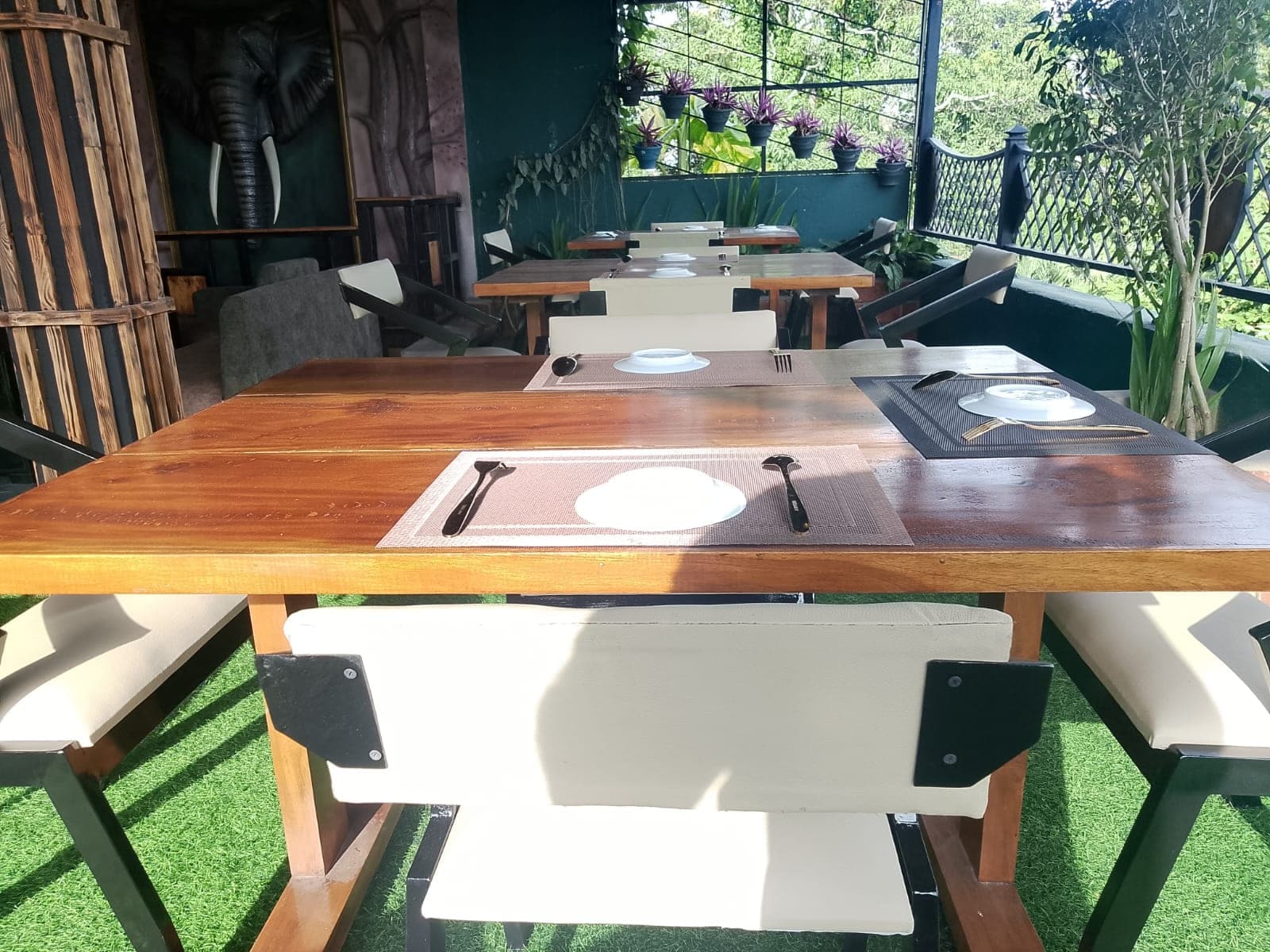 A wooden table laid for two on the terrace